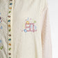 secret of the sea embroidery shell shirt in jellyfish by benang jarum embroidery logo detail